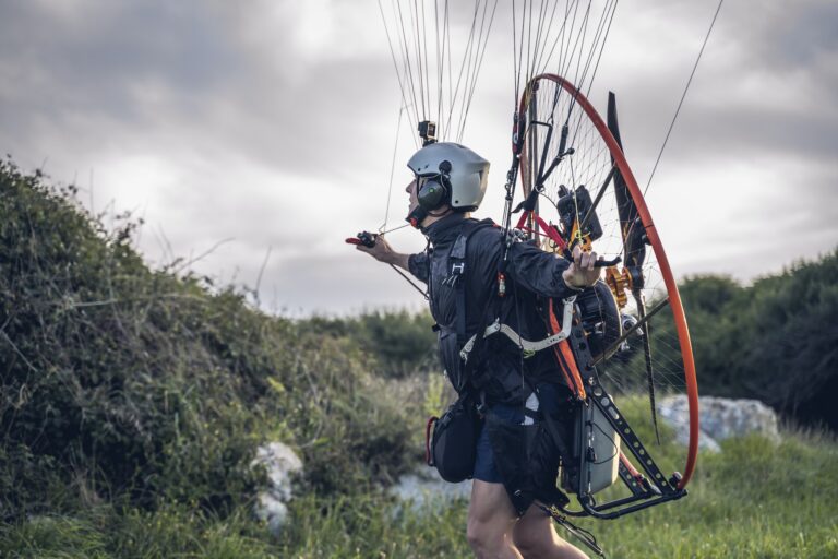 Young man, with the Powered Paragliding engine in his shoulders